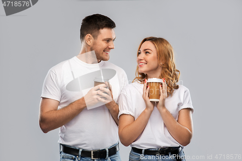 Image of portrait of happy couple with takeaway coffee cups