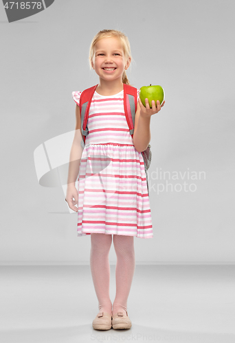 Image of little school girl with green apple