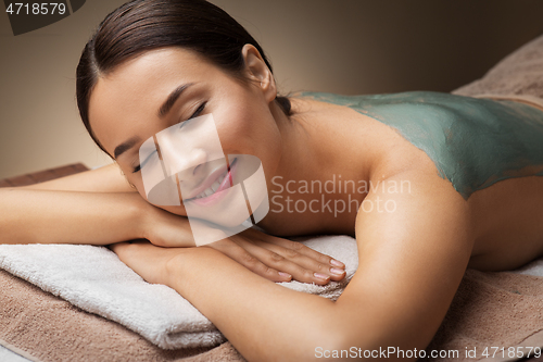 Image of woman with blue clay mask in spa