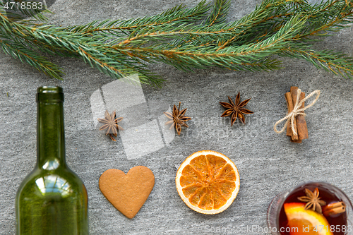 Image of mulled wine, orange slices, gingerbread and spices