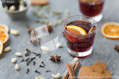 Image of hot mulled wine, orange slices, raisins and spices