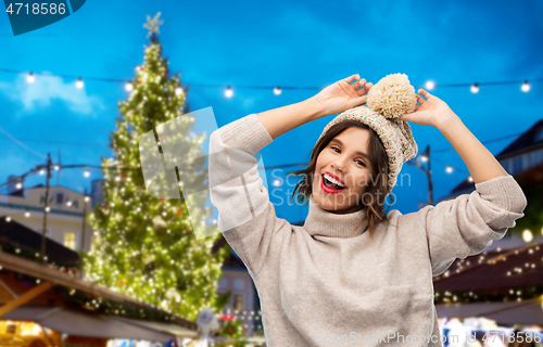 Image of woman in hat and sweater at christmas market