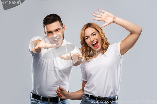 Image of portrait of happy couple in white t-shirts dancing