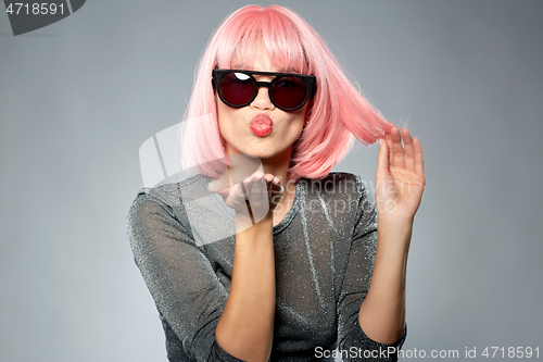 Image of woman in pink wig and sunglasses sending air kiss