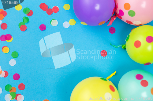 Image of party balloons and confetti on blue background