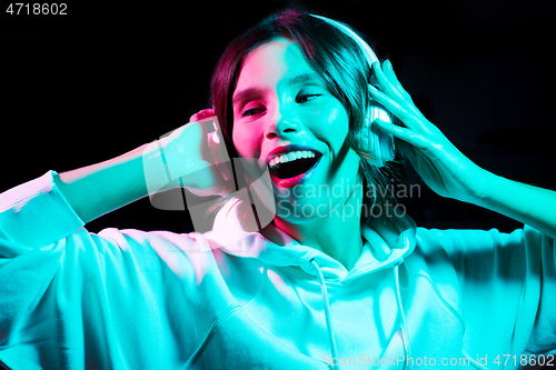 Image of woman in headphones listening to music and dancing