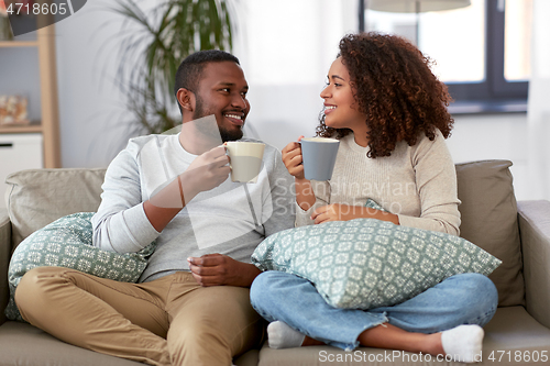 Image of african american couple drinking coffee at home
