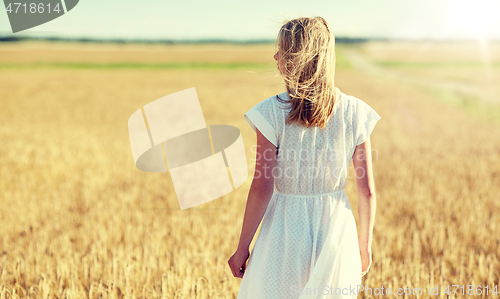 Image of young woman in white dress on cereal field