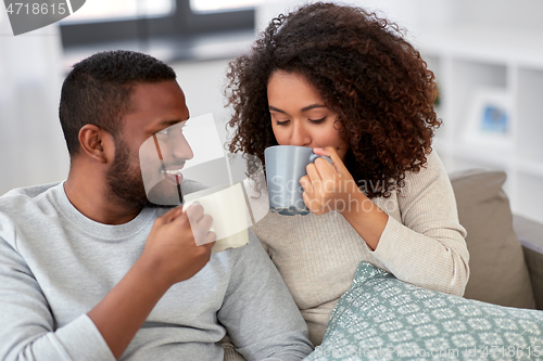 Image of african american couple drinking coffee at home