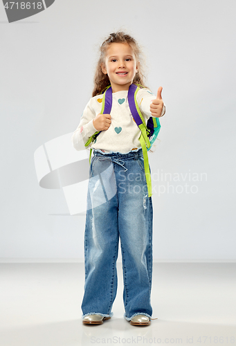 Image of happy girl with school backpack showing thumbs up