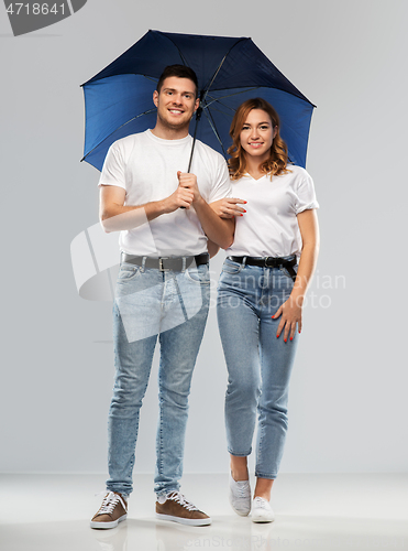 Image of happy couple in white t-shirts with umbrella