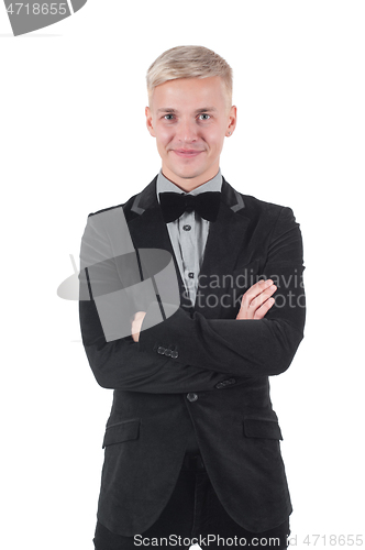 Image of Man in jacket and bow-tie standing with crossed arms