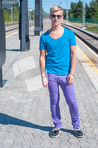 Image of Good looking caucasian male outdoors in railway platform
