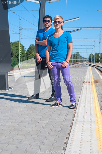 Image of Shot of two young men standing on platform