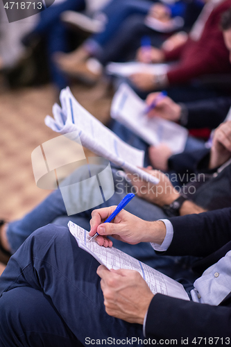 Image of business people taking notes