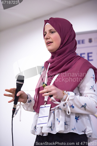 Image of Muslim businesswoman giving presentations at conference room