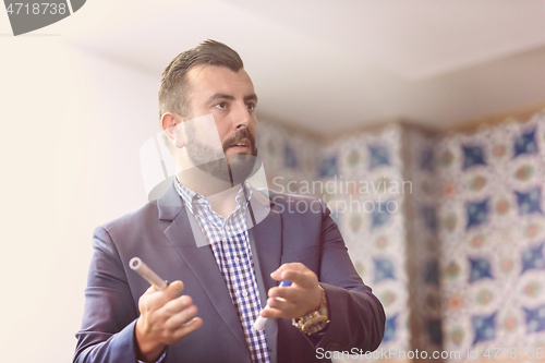 Image of businessman giving presentations at conference room