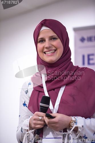 Image of Muslim businesswoman giving presentations at conference room