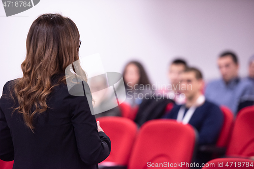 Image of businesswoman giving presentations at conference room