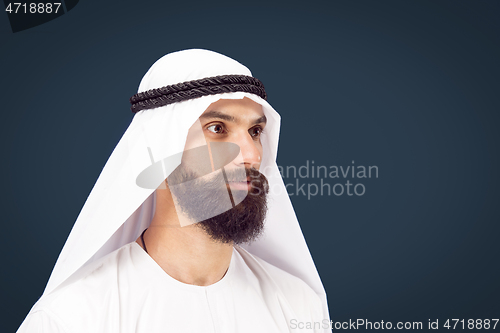 Image of Arabian saudi businessman on dark blue studio background