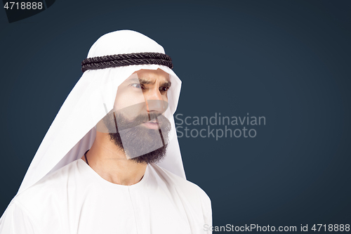 Image of Arabian saudi businessman on dark blue studio background