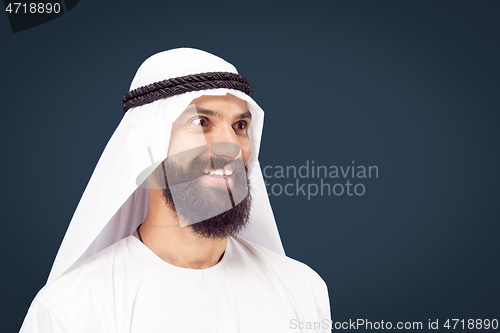 Image of Arabian saudi businessman on dark blue studio background