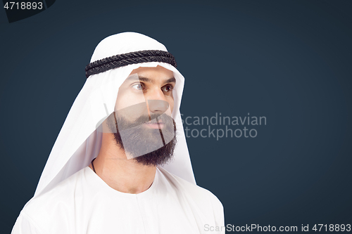 Image of Arabian saudi businessman on dark blue studio background