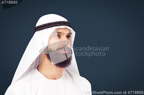 Image of Arabian saudi businessman on dark blue studio background