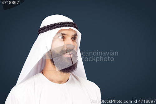 Image of Arabian saudi businessman on dark blue studio background