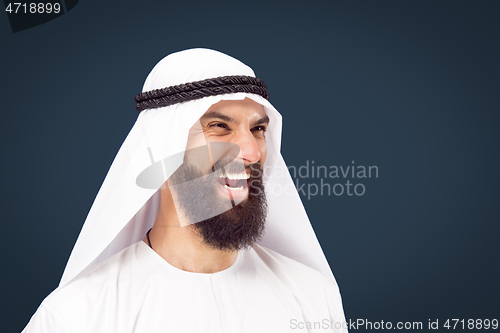 Image of Arabian saudi businessman on dark blue studio background