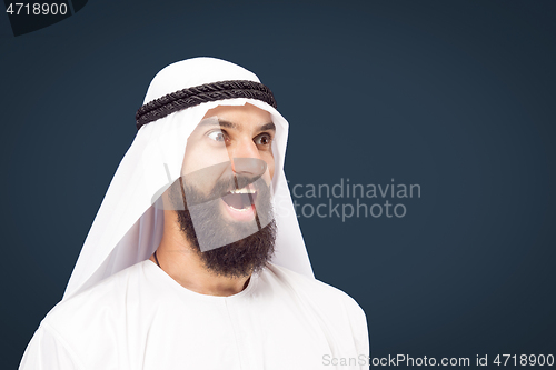 Image of Arabian saudi businessman on dark blue studio background