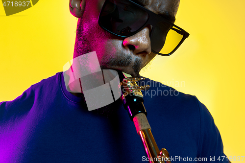 Image of Young african-american jazz musician playing the saxophone