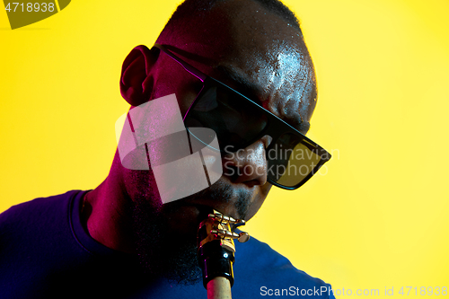 Image of Young african-american jazz musician playing the saxophone