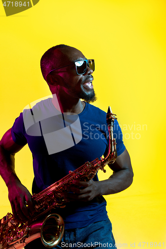 Image of Young african-american jazz musician playing the saxophone