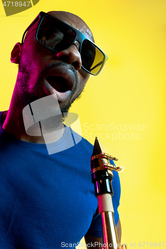 Image of Young african-american jazz musician playing the saxophone