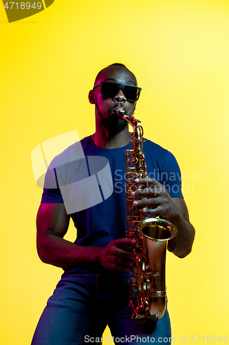 Image of Young african-american jazz musician playing the saxophone