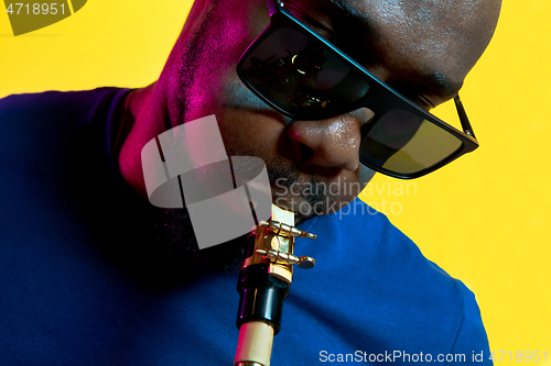 Image of Young african-american jazz musician playing the saxophone