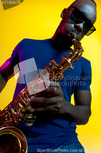 Image of Young african-american jazz musician playing the saxophone