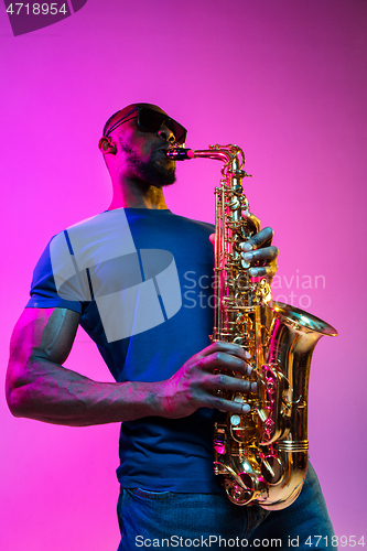 Image of Young african-american jazz musician playing the saxophone