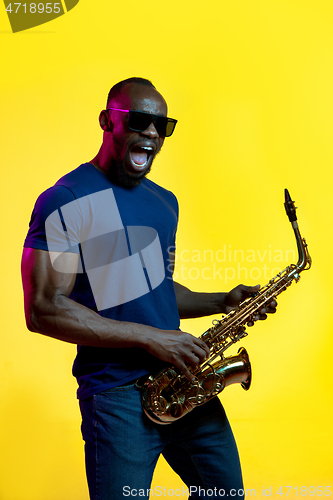 Image of Young african-american jazz musician playing the saxophone