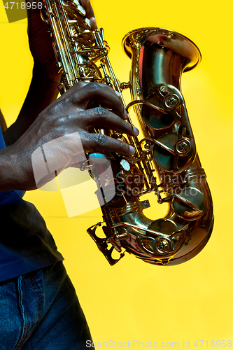 Image of Young african-american jazz musician playing the saxophone