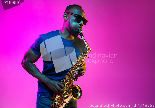 Image of Young african-american jazz musician playing the saxophone