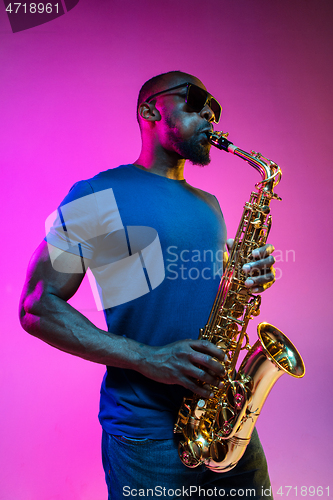 Image of Young african-american jazz musician playing the saxophone