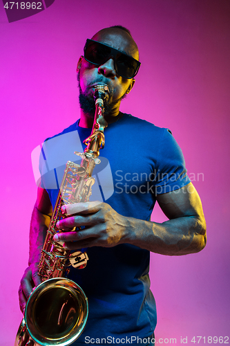 Image of Young african-american jazz musician playing the saxophone