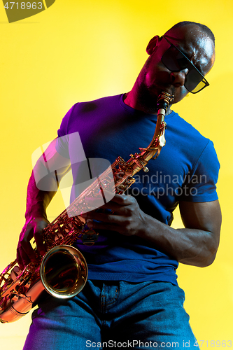 Image of Young african-american jazz musician playing the saxophone