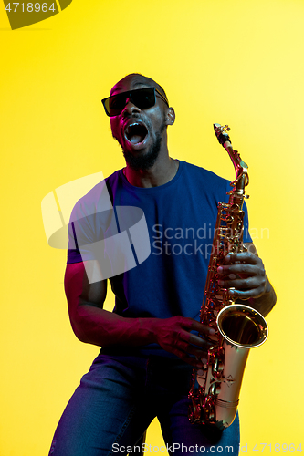 Image of Young african-american jazz musician playing the saxophone