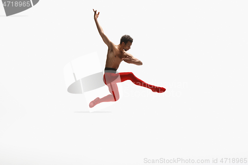 Image of Young graceful male ballet dancer dancing on white studio background