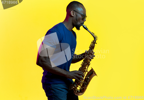 Image of Young african-american jazz musician playing the saxophone