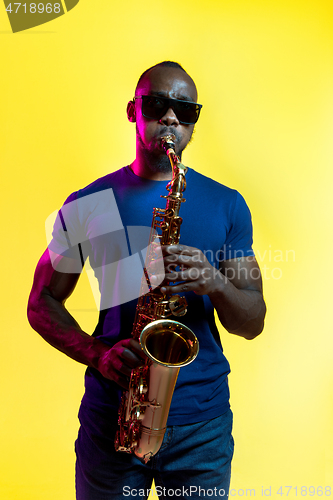 Image of Young african-american jazz musician playing the saxophone