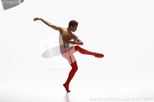 Image of Young graceful male ballet dancer dancing on white studio background